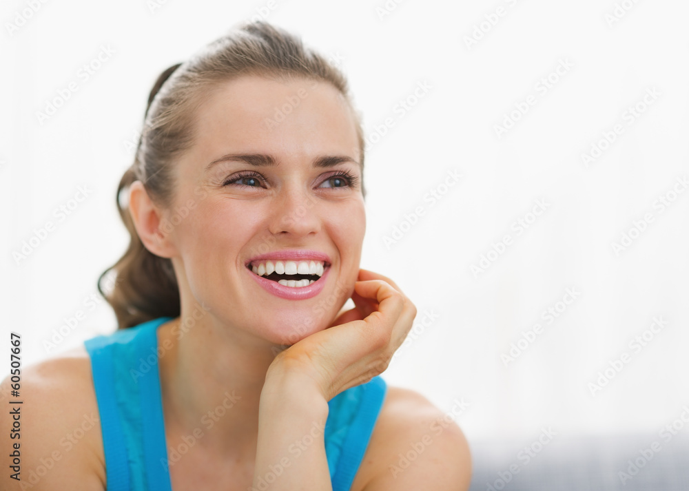 Portrait of smiling young woman sitting in living room Portrait of smiling young woman sitting in living room