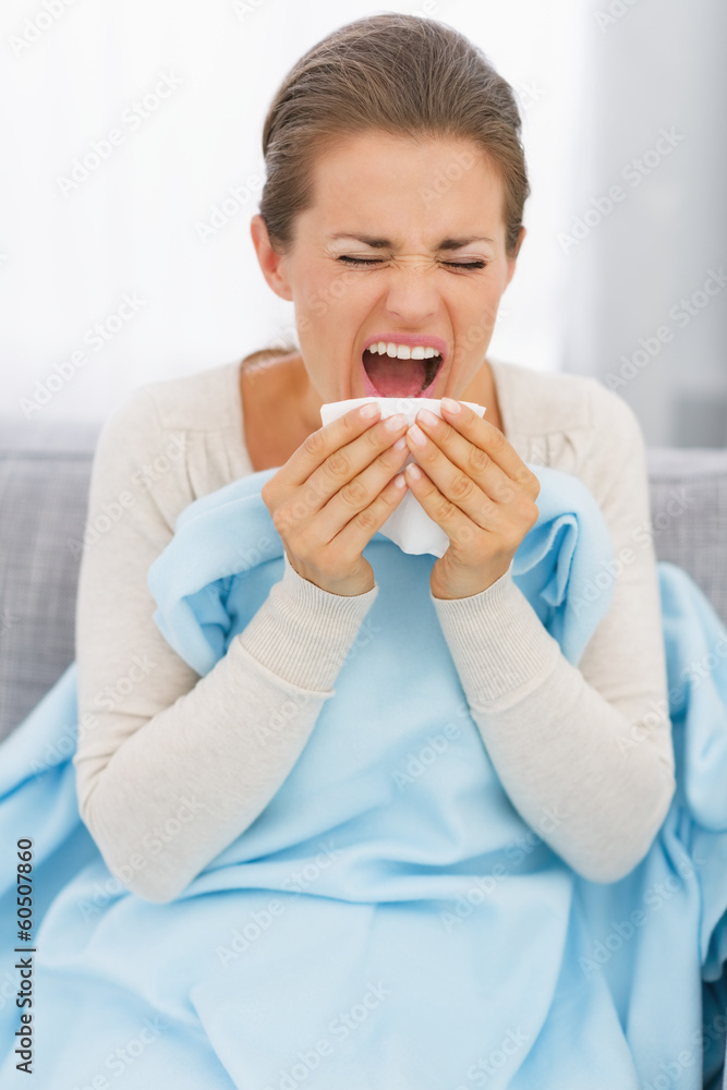 Young woman sneezing Young woman sneezing