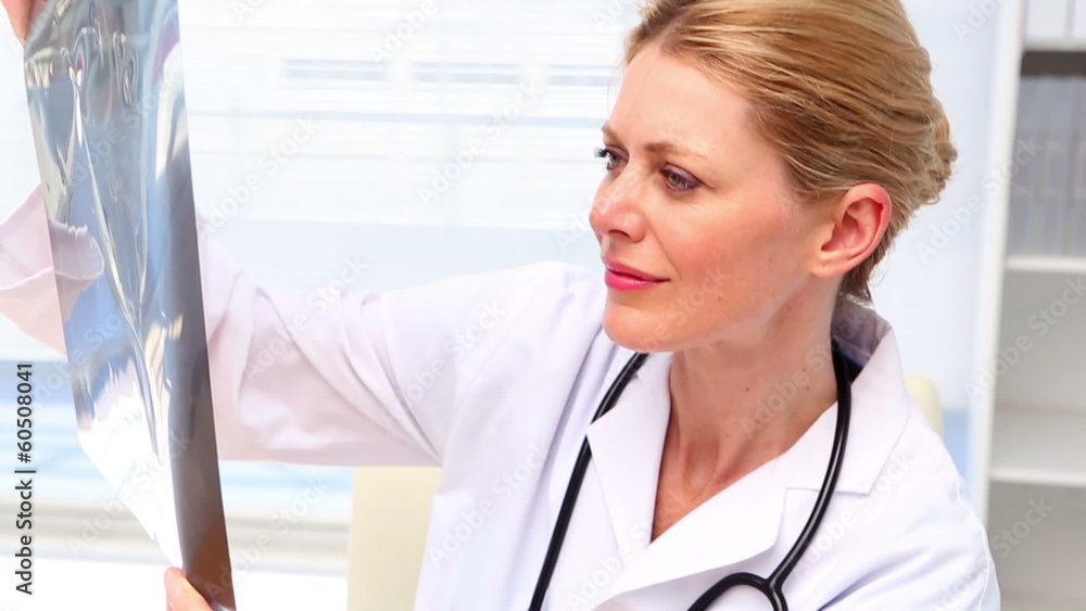 Doctor looking at xray at her desk Doctor looking at xray at her desk