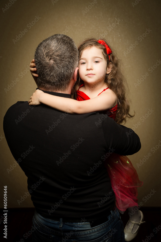 Girl on the hands of the dad and hugs him Girl on the hands of the dad and hugs him