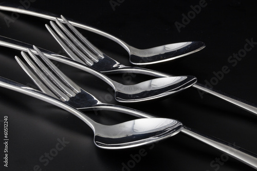 Forks and spoons on a black table