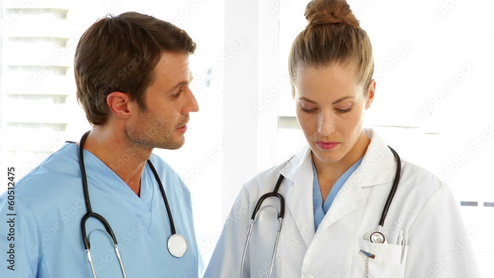 Doctor and surgeon analyzing results together Doctor and surgeon analyzing results together
