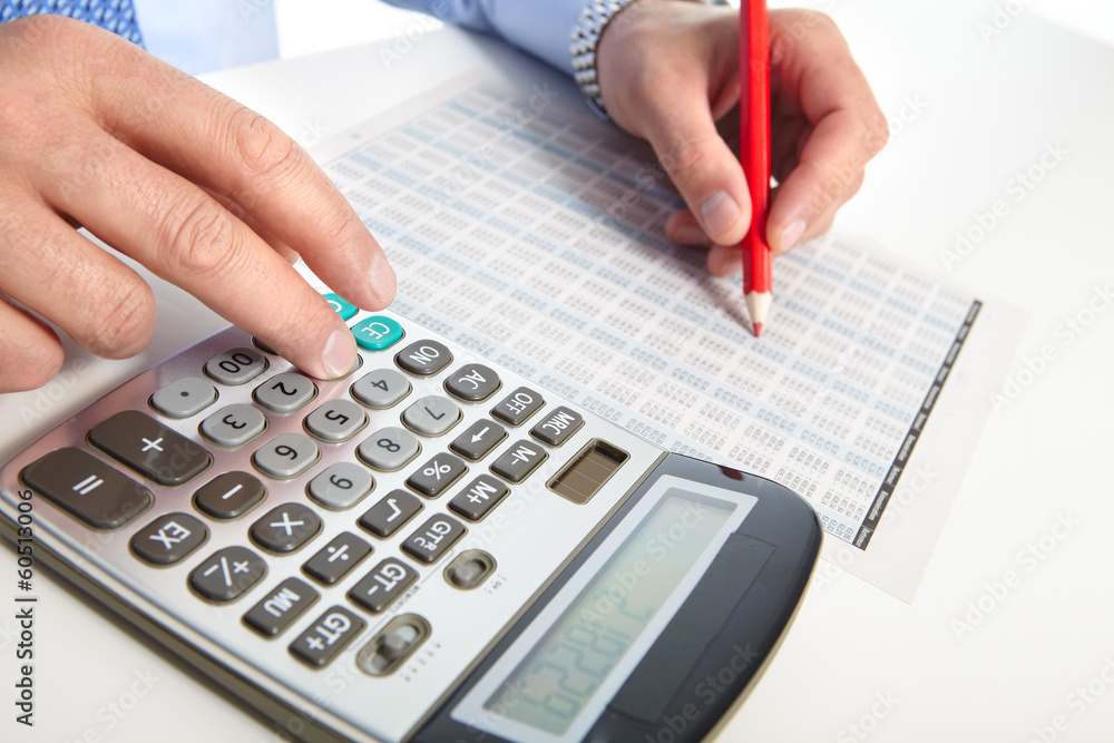 The businessman and green calculator The businessman and green calculator