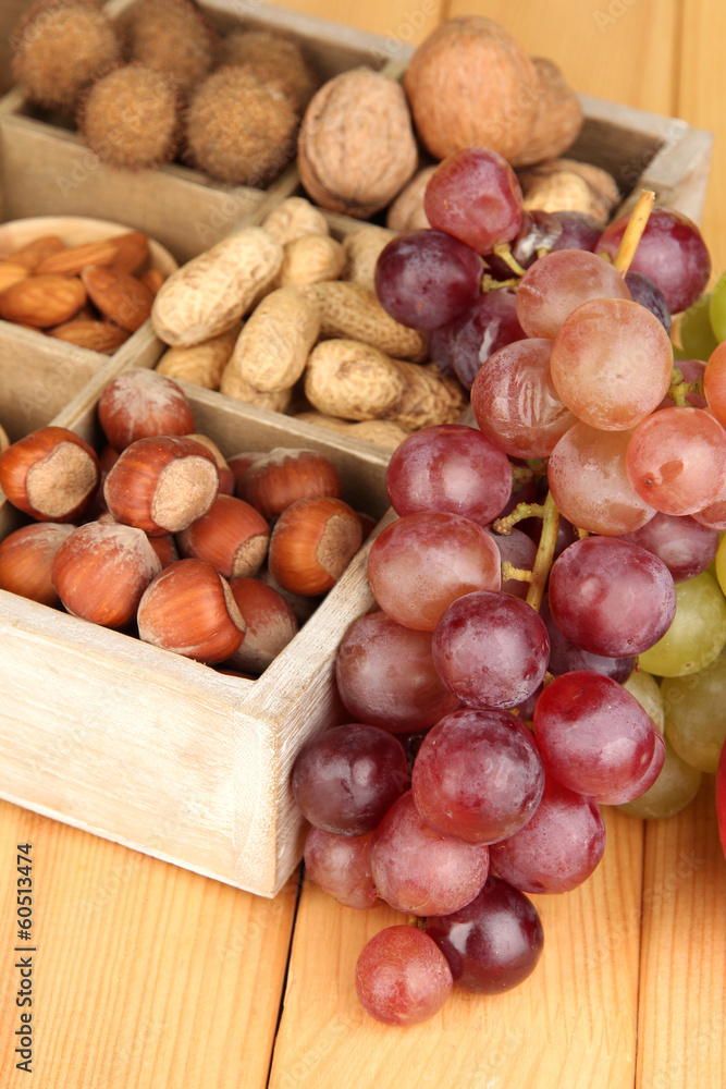 Grape with nuts on wooden table