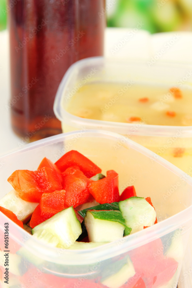 Tasty lunch in plastic containers, on wooden background Tasty lunch in plastic containers, on wooden background