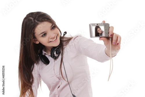 Cheerful schoolgirl taking her own pictures