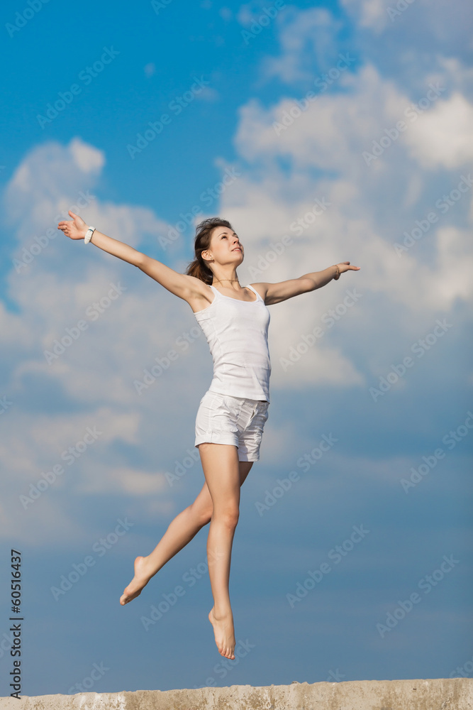 Young woman jumping outdoors