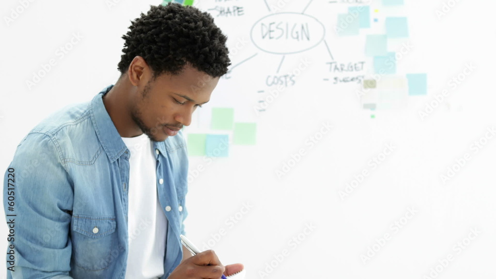 Focused creative designer working on his tablet Focused creative designer working on his tablet