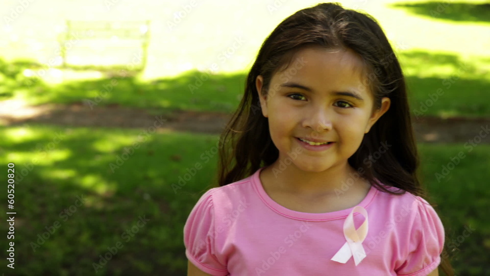 Smiling little girl wearing pink for breast cancer awareness Smiling little girl wearing pink for breast cancer awareness