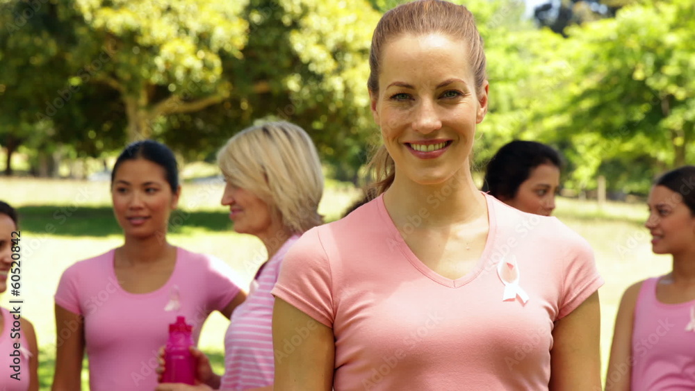 Activists for breast cancer awareness one smiling at camera Activists for breast cancer awareness one smiling at camera