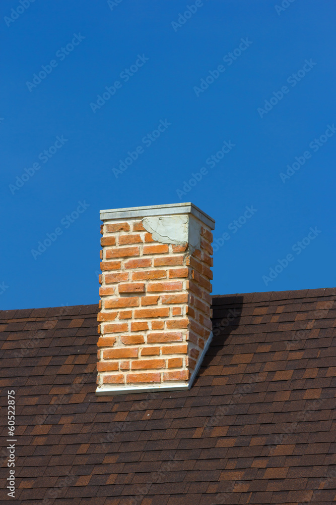 The brick chimney in bright sunlight a deep blue sky vertical The brick chimney in bright sunlight a deep blue sky vertical