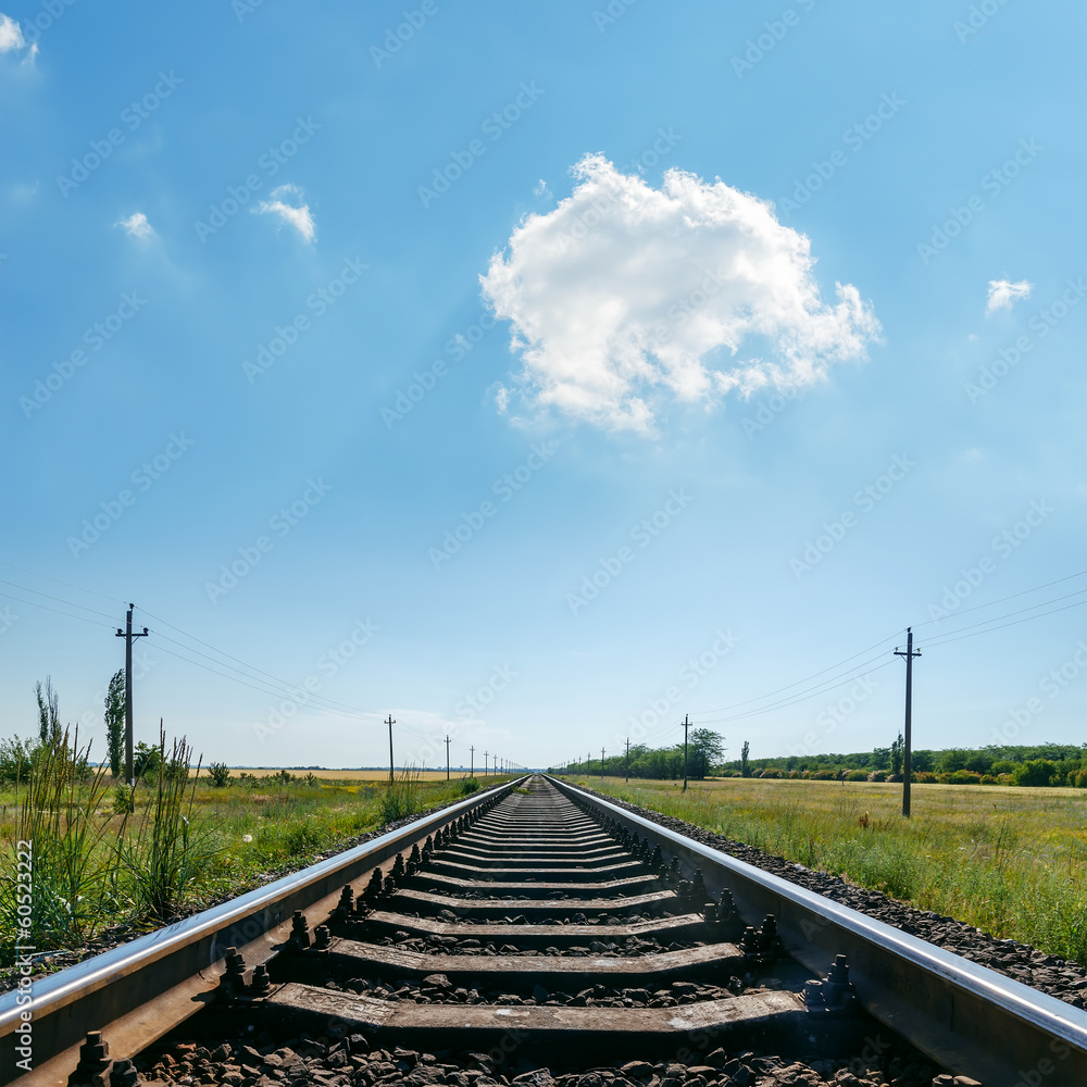 cloud in blue sky over railroad