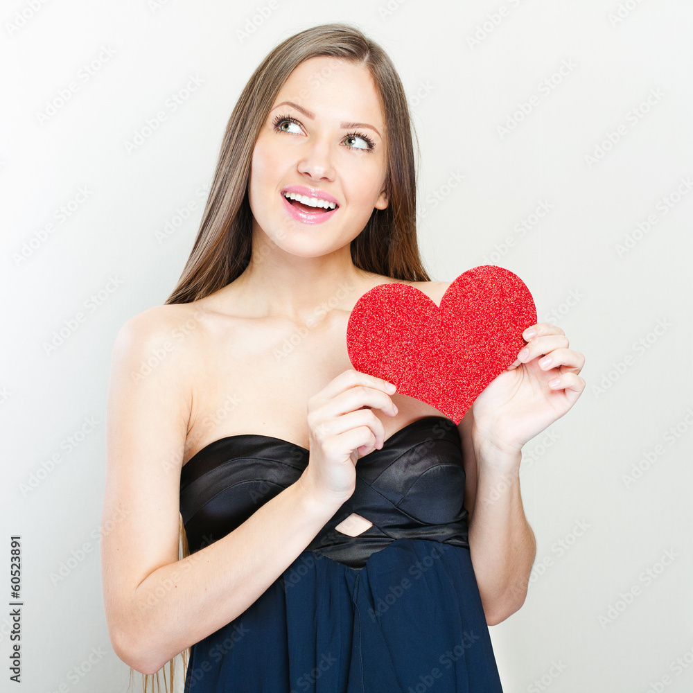 Young happy woman holding red heart. Young happy woman holding red heart.