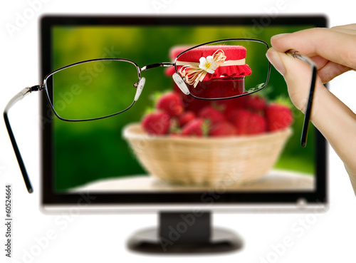 Man is viewing to strawberries on display