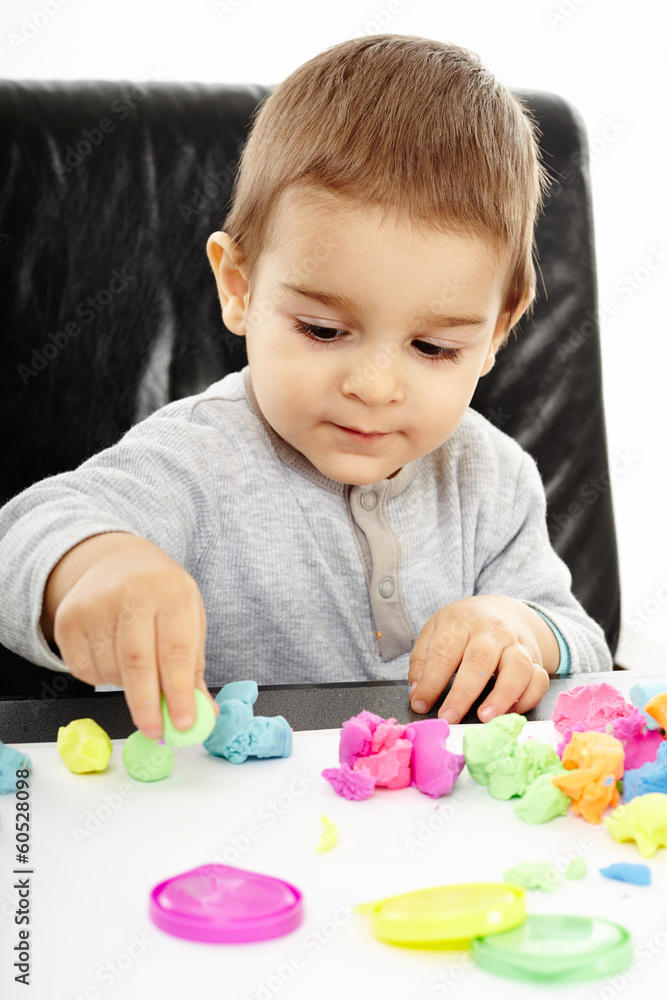 Little boy playing with plasticine Little boy playing with plasticine
