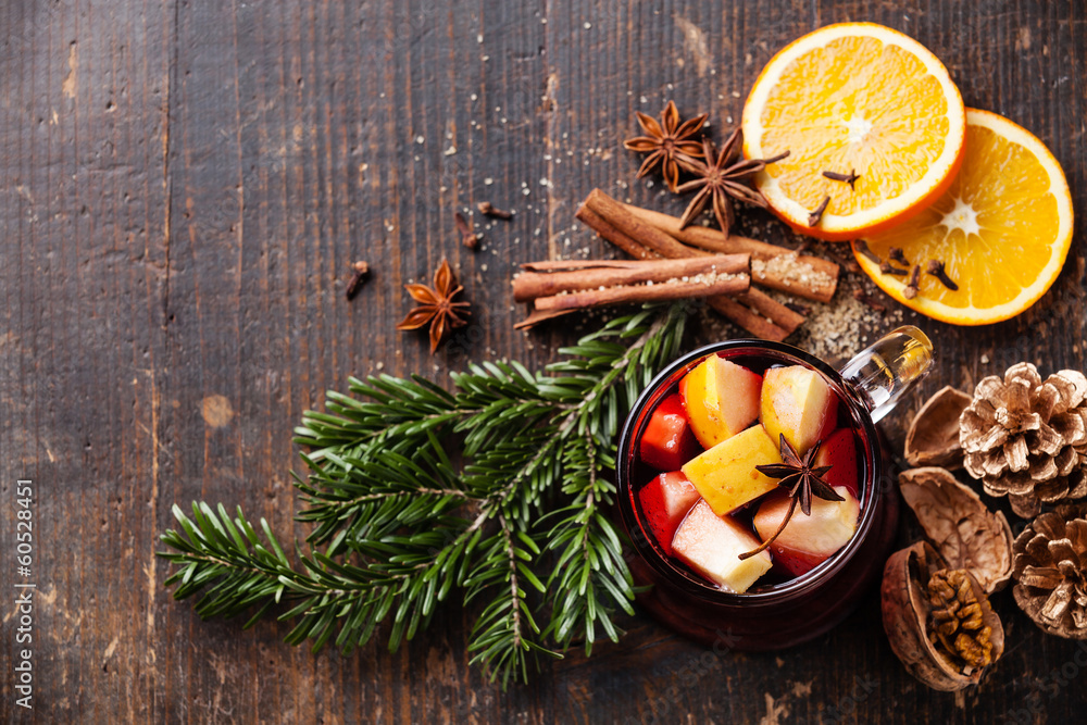 Cup of hot wine with spices on wooden background Cup of hot wine with spices on wooden background