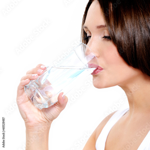 Young smiling woman holds glass of water