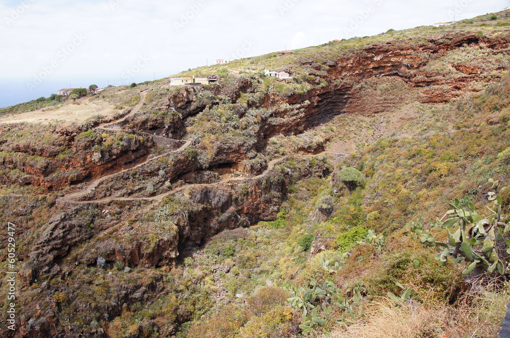 Volcanic landscape, typical houses, wild vegetation Volcanic landscape, typical houses, wild vegetation