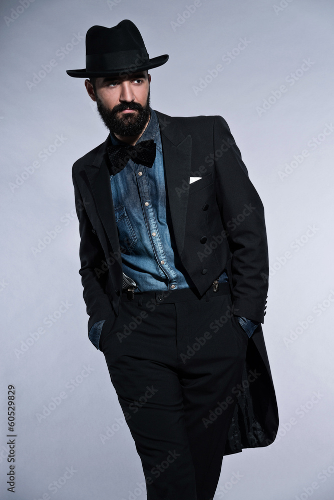 Retro hipster 1900 fashion man in suit with black hair and beard Retro hipster 1900 fashion man in suit with black hair and beard