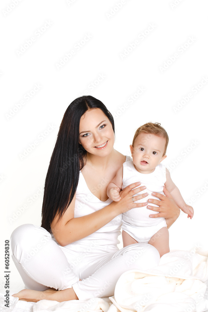 Portrait of mother and baby kissing, laughing and hugging Portrait of mother and baby kissing, laughing and hugging
