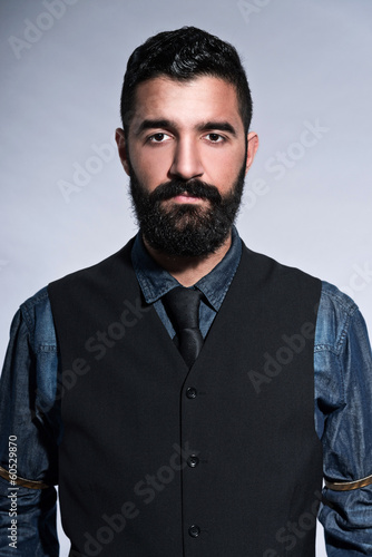 Retro hipster 1900 fashion man in suit with black hair and beard