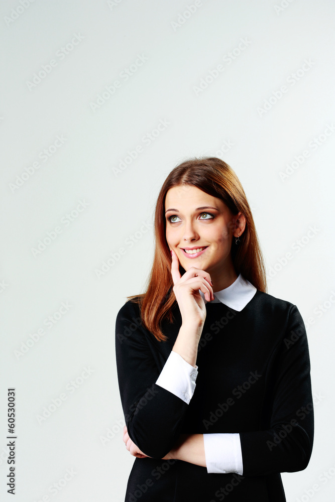 Young thoughtful happy woman looking up at copyspace Young thoughtful happy woman looking up at copyspace