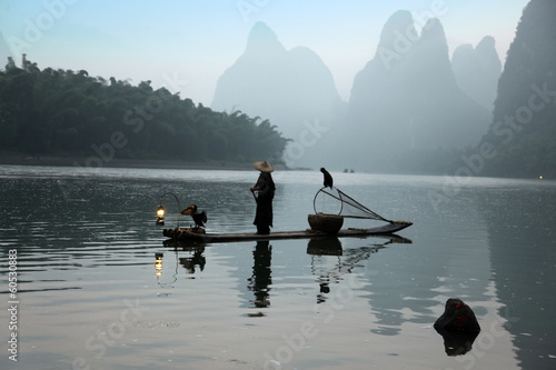 Chinese man fishing with cormorants birds