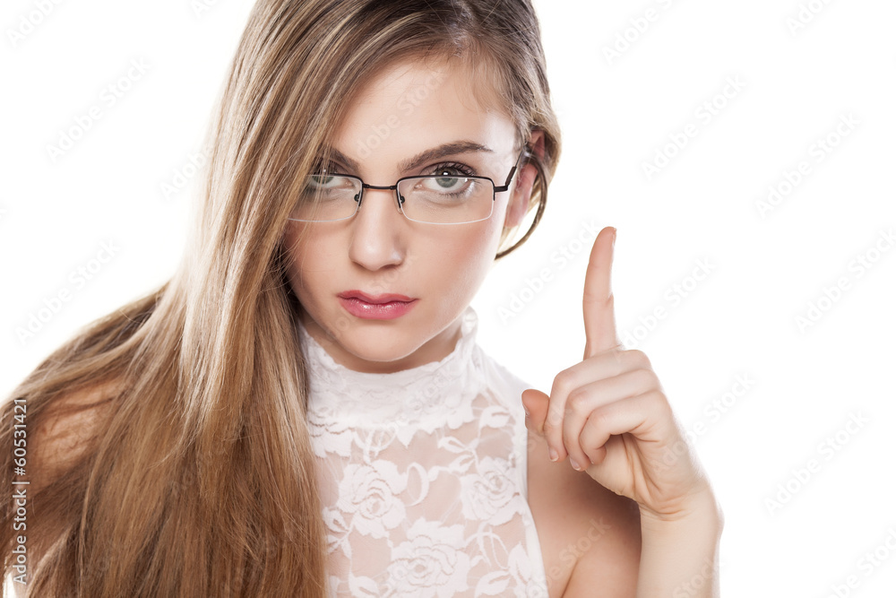 angry girl with glasses shows a finger upwards angry girl with glasses shows a finger upwards