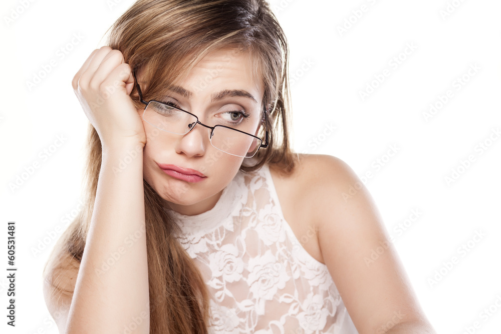 unhappy and thoughtful girl with glasses posing on white unhappy and thoughtful girl with glasses posing on white