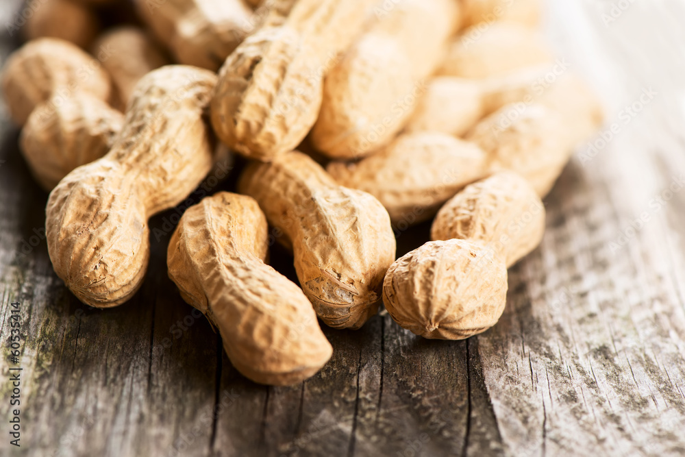 Peanuts in shell on wooden table horizontal