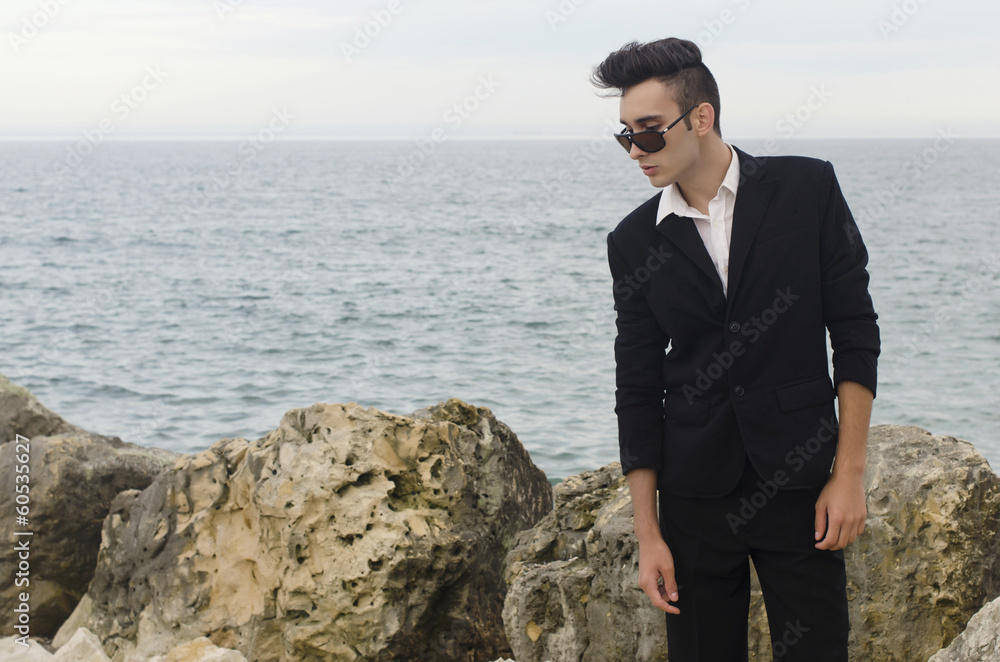 Businessman wearing sunglasses relax on a beach Businessman wearing sunglasses relax on a beach