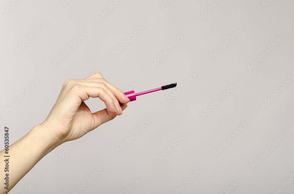 Close up on a woman hand holding a make up brush Close up on a woman hand holding a make up brush