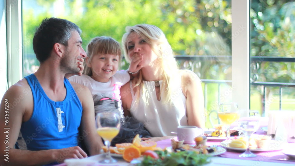 happy parents and their daughter in the kitchen happy parents and their daughter in the kitchen