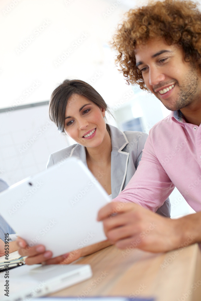 Young business people in office using tablet Young business people in office using tablet