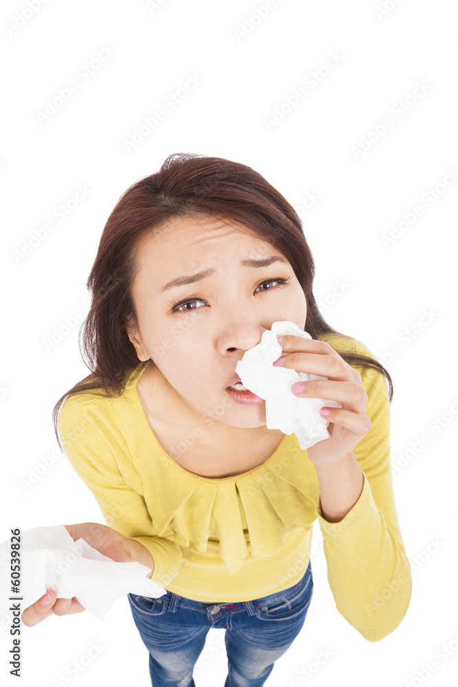 Sneezing and blowing nose,  young woman struggles with cold