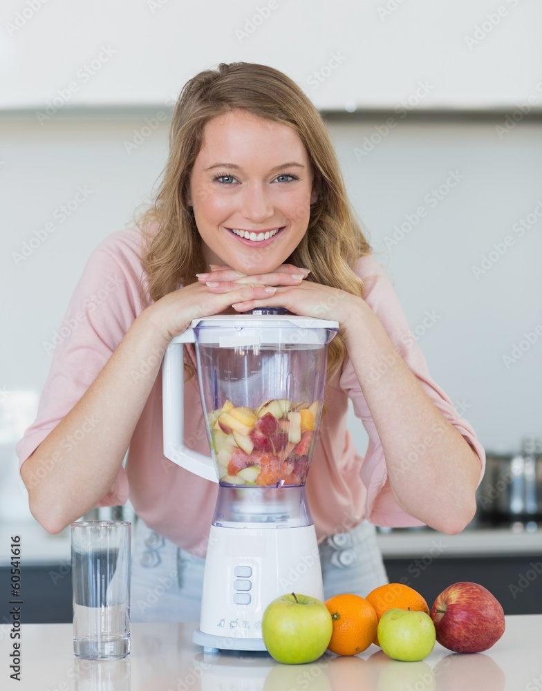 Woman preparing mix fruit juice in liquidizer Woman preparing mix fruit juice in liquidizer