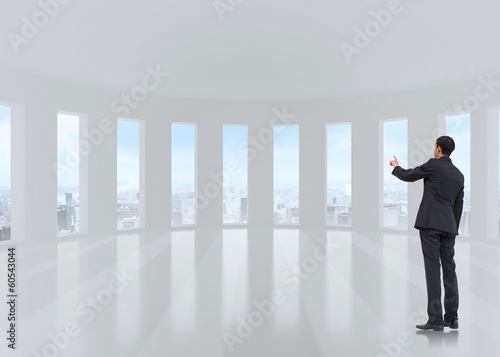Composite image of asian businessman pointing