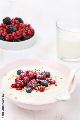 semolina porridge with fresh berries  nuts and glass of milk