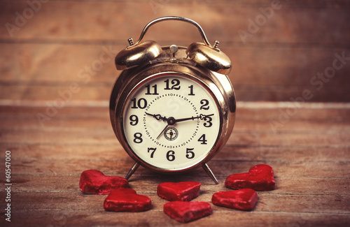 Retro alarm clock with cookie on a table