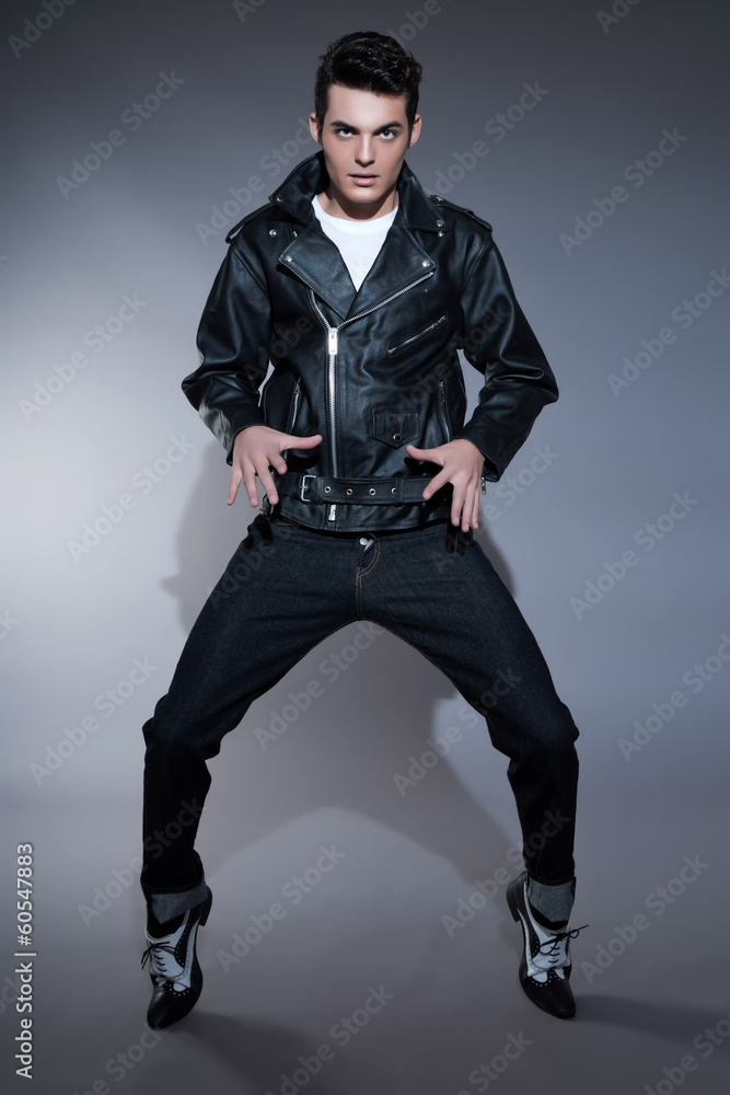 Retro rock and roll 50s fashion man with dark grease hair. Weari Stock  Photo