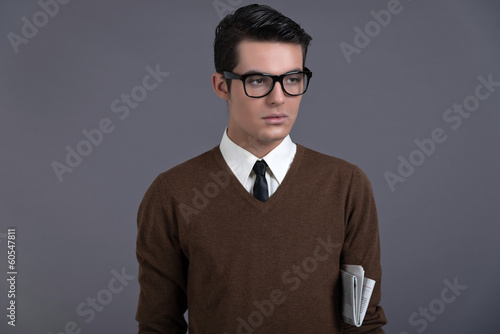 Retro fifties fashion man with dark grease hair. Wearing brown s