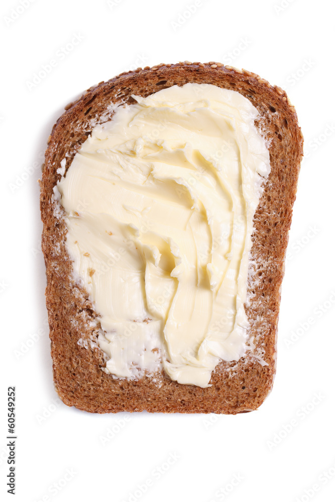 a slice of rye bread with butter close up isolated on white a slice of rye bread with butter close up isolated on white