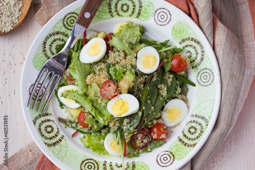 Healthy quinoa salad with tomatoes, avocados, eggs, lettuce