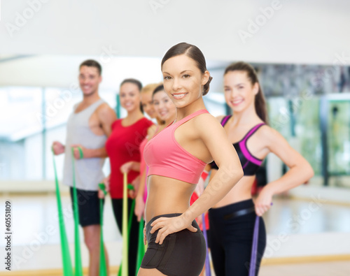 personal trainer with group in gym