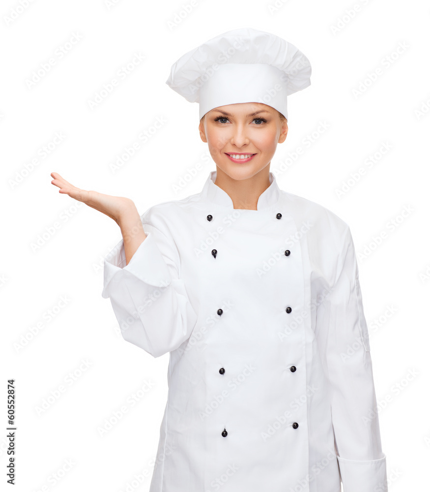 smiling female chef holding something on hand smiling female chef holding something on hand