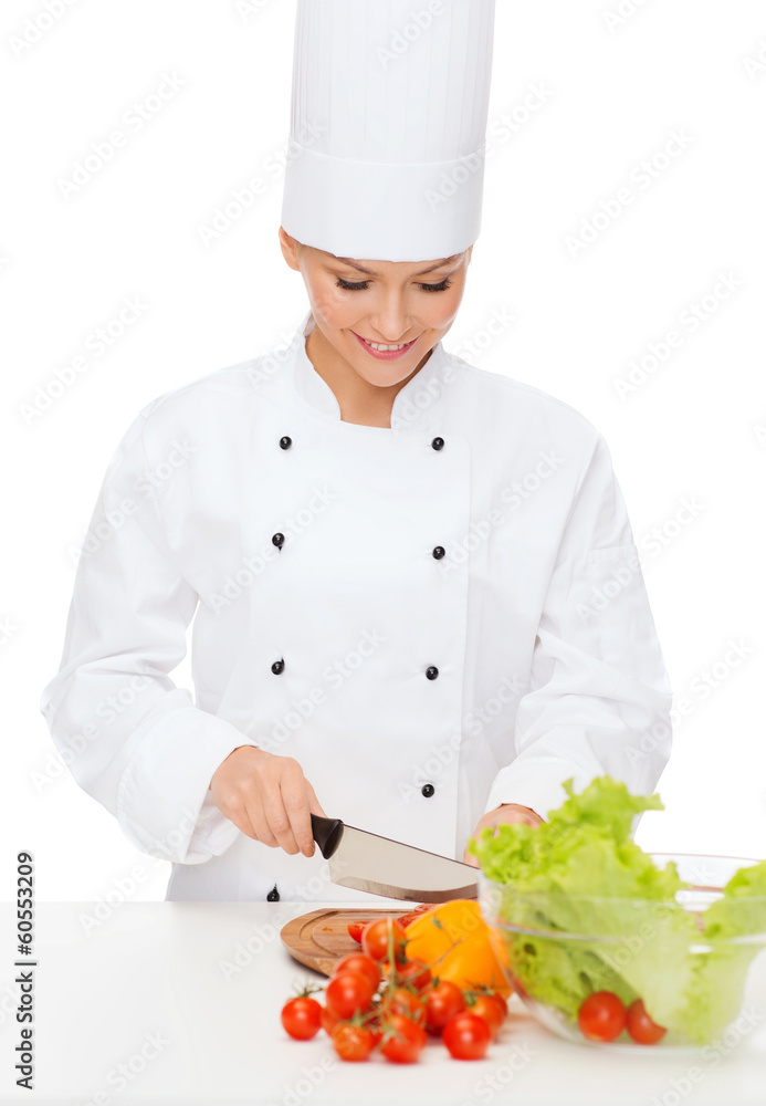 smiling female chef chopping vagetables smiling female chef chopping vagetables