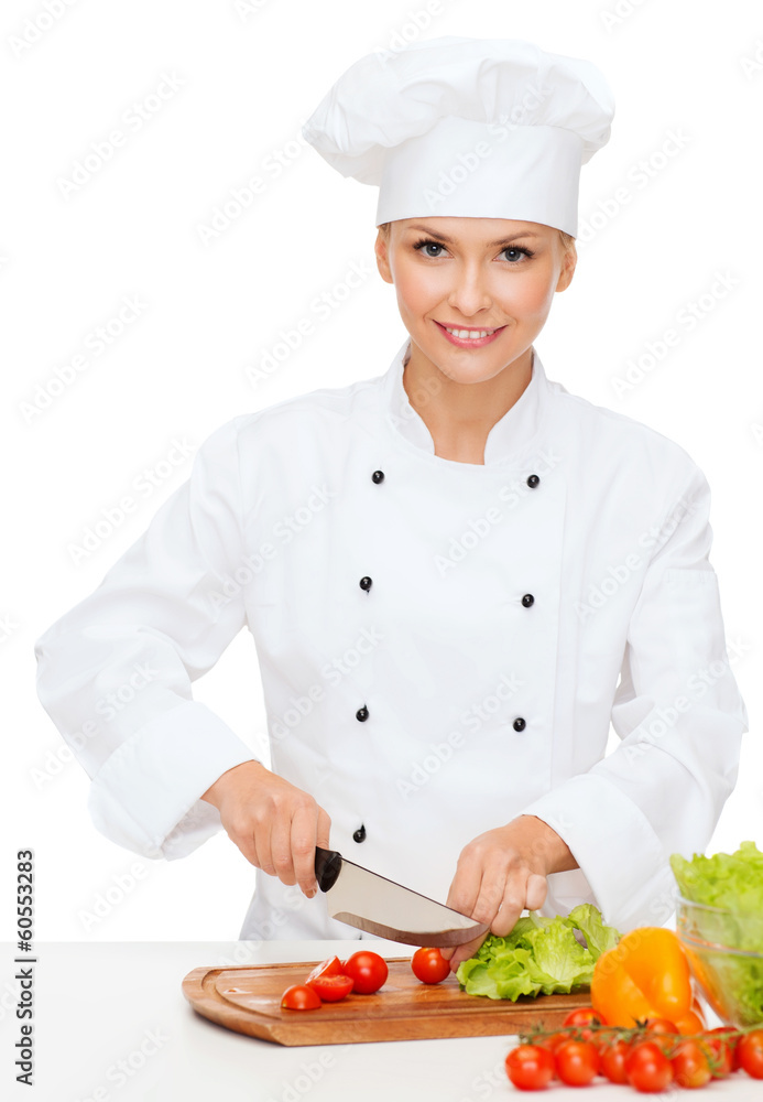 smiling female chef chopping vagetables smiling female chef chopping vagetables