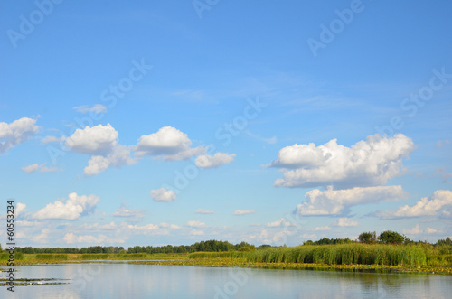 Summer sky over the calm lake.