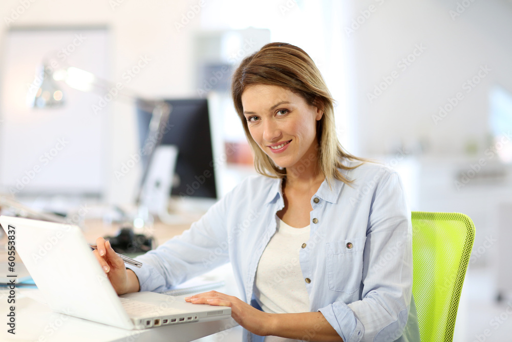 Smiling businesswoman working in office Smiling businesswoman working in office