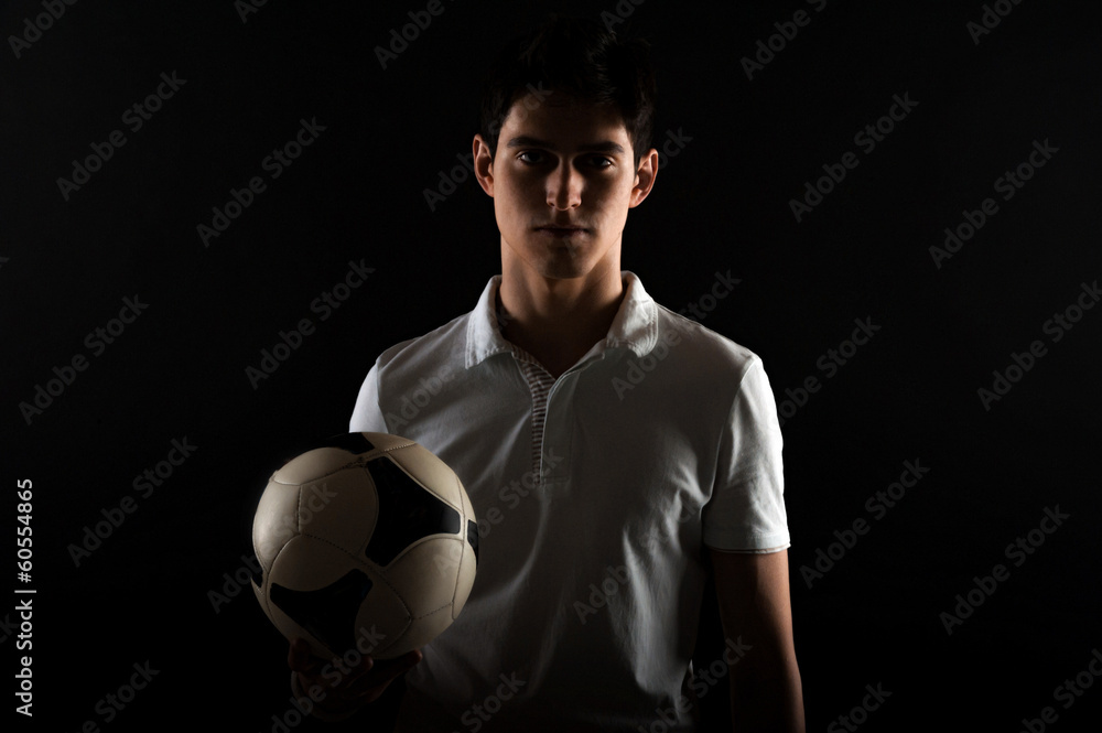 Portrait og young man football player with ball in hand Portrait og young man football player with ball in hand